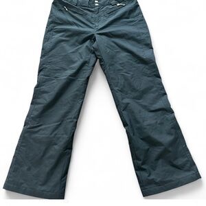 Black ski pants with adjustable waist and ankles, featuring multiple pockets